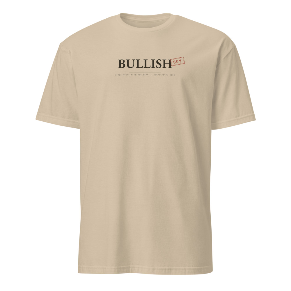 Sand t-shirt reading BULLISH in dark ink with a rotated red BUY rubber stamp struck across the end
